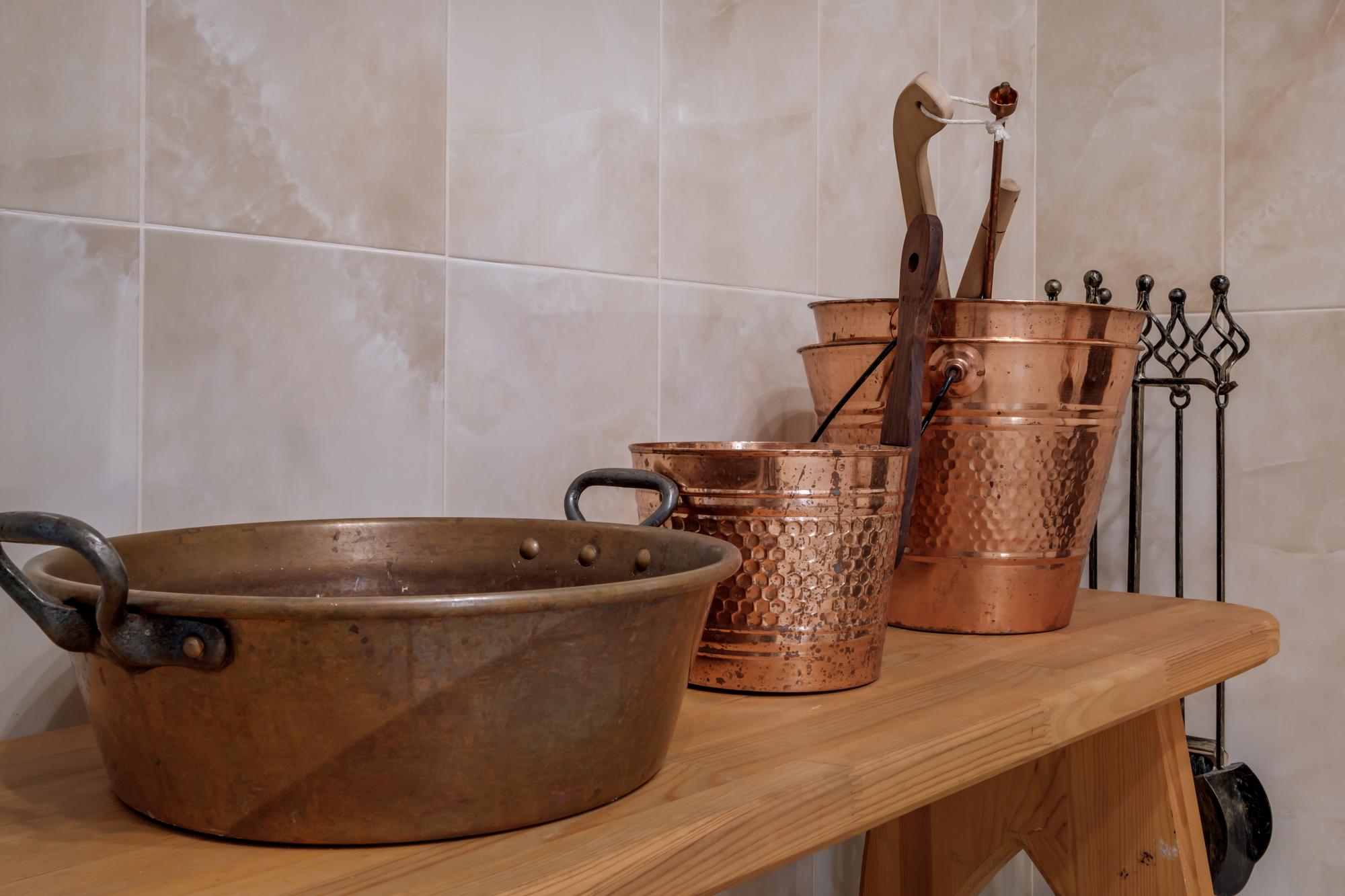Interior of small artisanal kitchen with copper pans